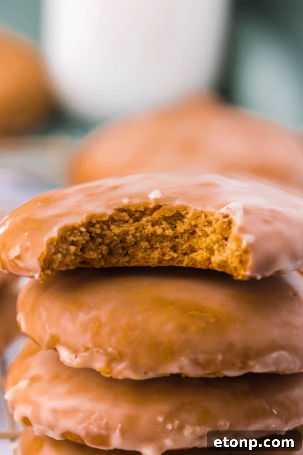 Cookies stacked on top of each other with one having a bite out of it, showing the soft interior