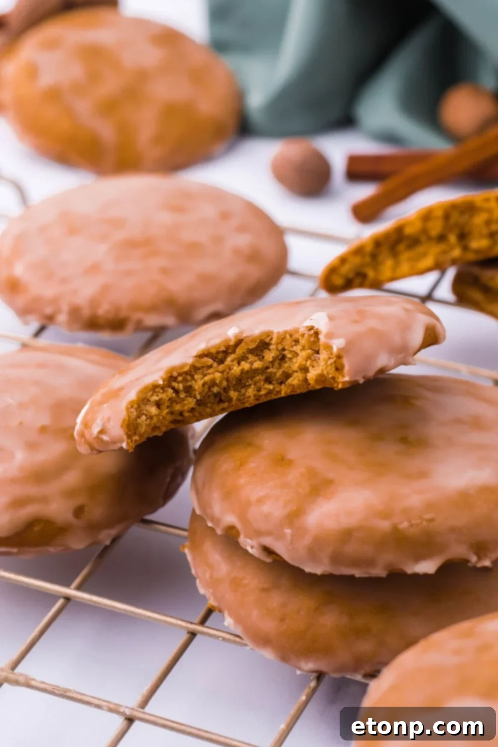 German cookie with a bite taken out, resting on a stack of other cookies