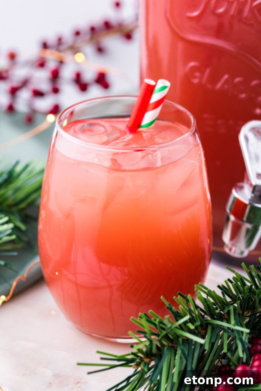 Holiday Punch in glass with straws on table 