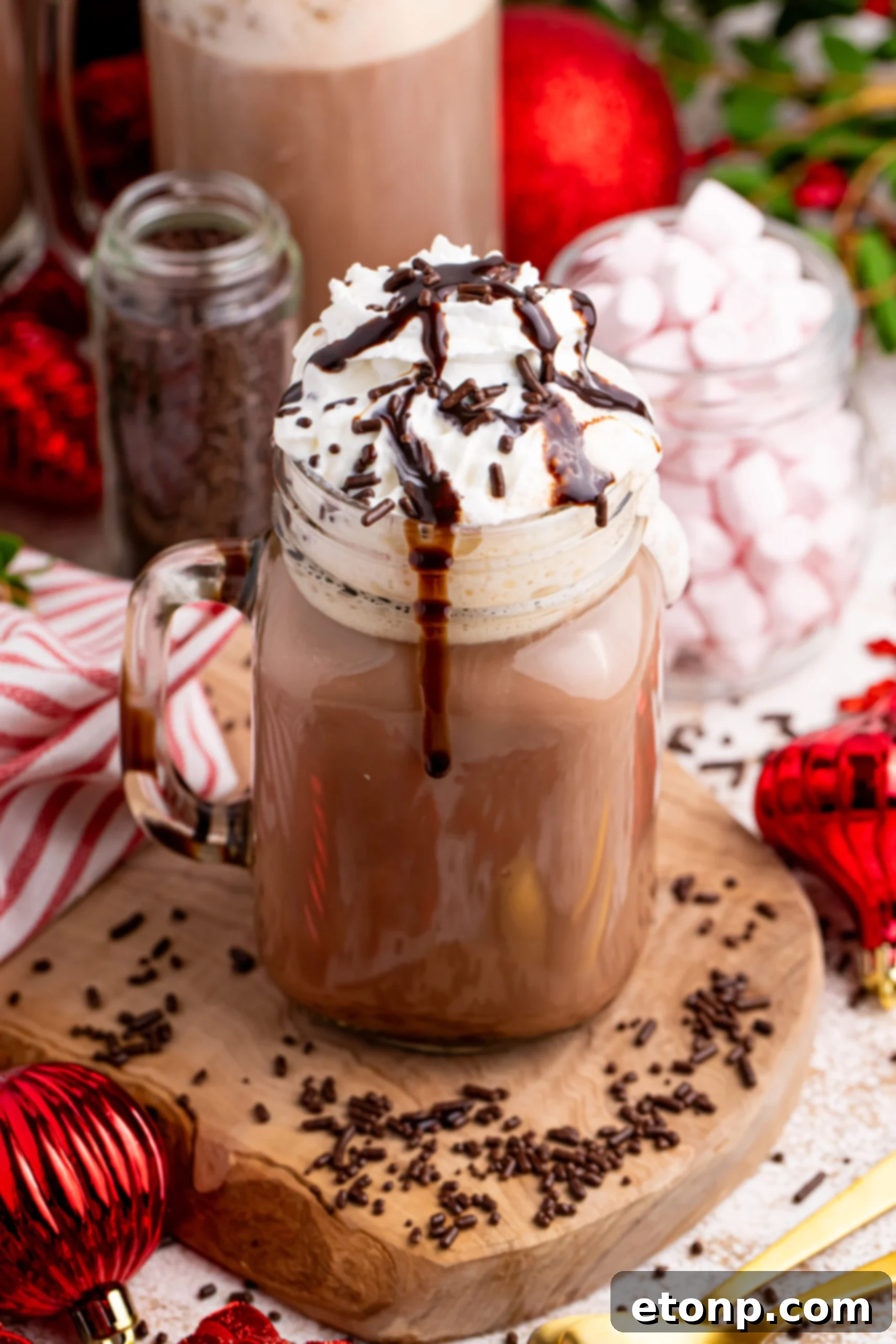 Naughty Snowman's Brew 2 Dirty Snowman on the table on a coaster with Christmas decorations around the glass with chocolate syrup drizzle