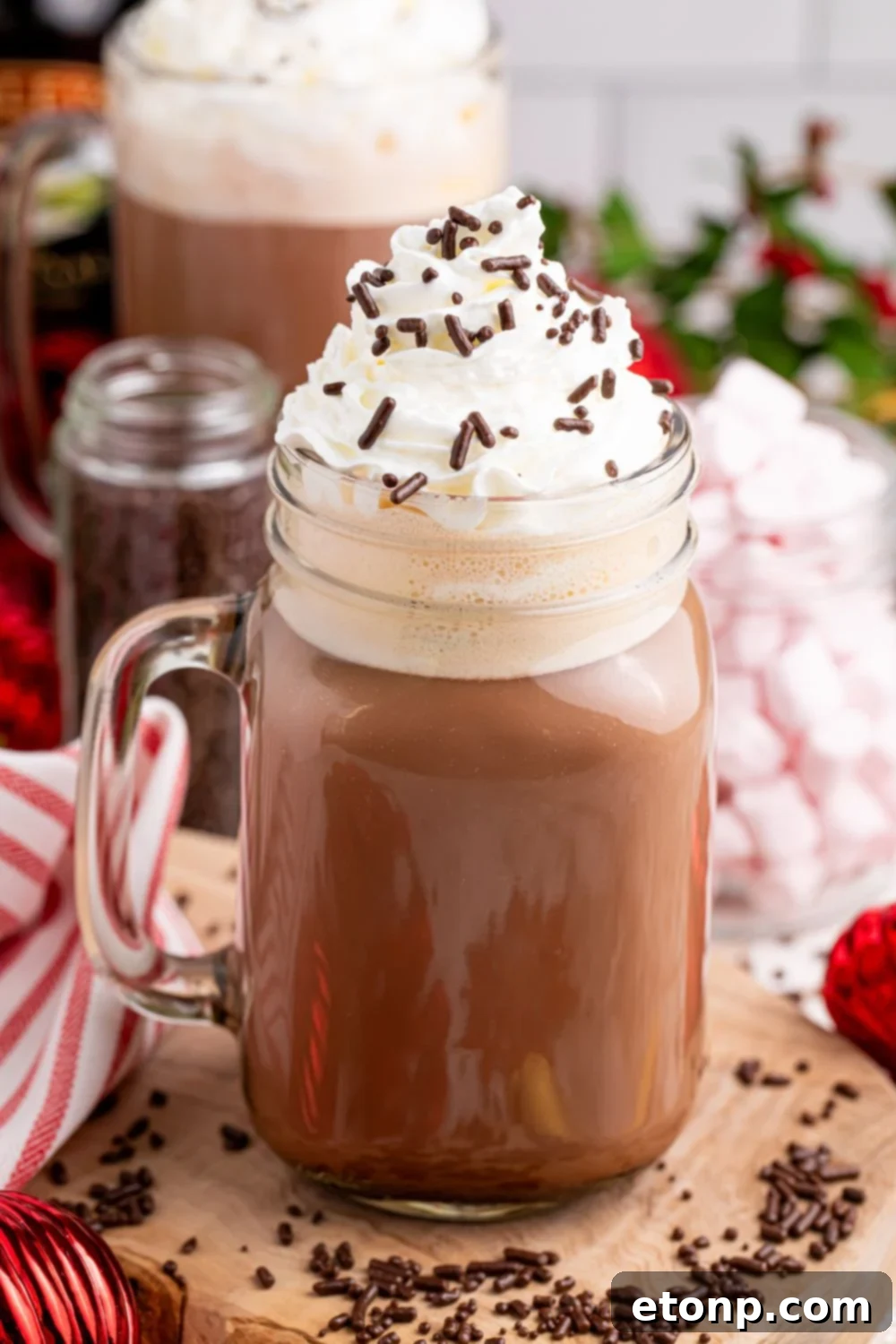 Naughty Snowman's Brew 13 a drunken hot chocolate drink on table with whipped cream and sprinkles on top