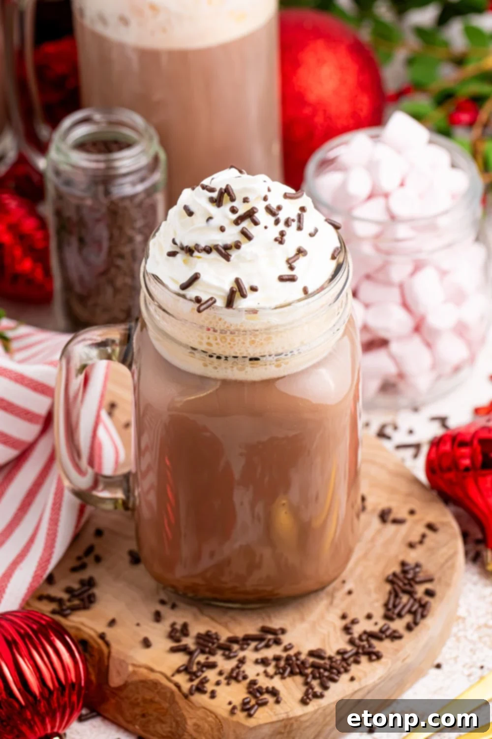 Naughty Snowman's Brew 15 Dirty Snowman (Adult Hot Chocolate) in a glass mason jar with a handle. Then you have mints in a jar and sprinkles around the table