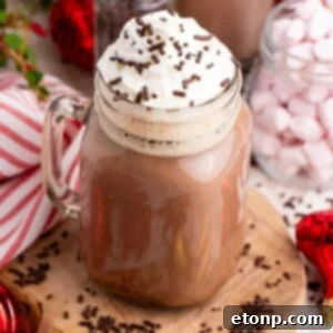 Dirty Snowman in a mason jar with a handle with whipped cream and sprinkles on top