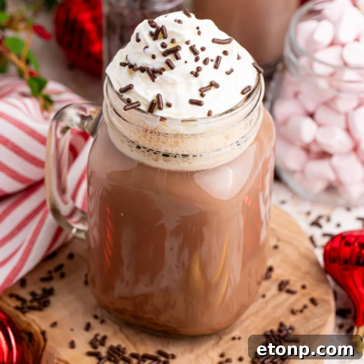 Naughty Snowman's Brew 4 dirty snowman drink in a mug on table with christmas decor behind it and around it
