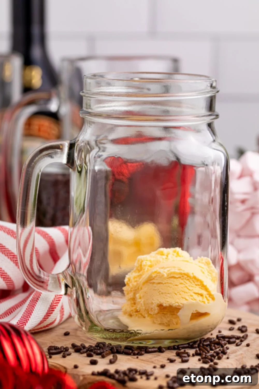 Naughty Snowman's Brew 7 scoop of vanilla ice cream in a glass mason jar sitting on a table