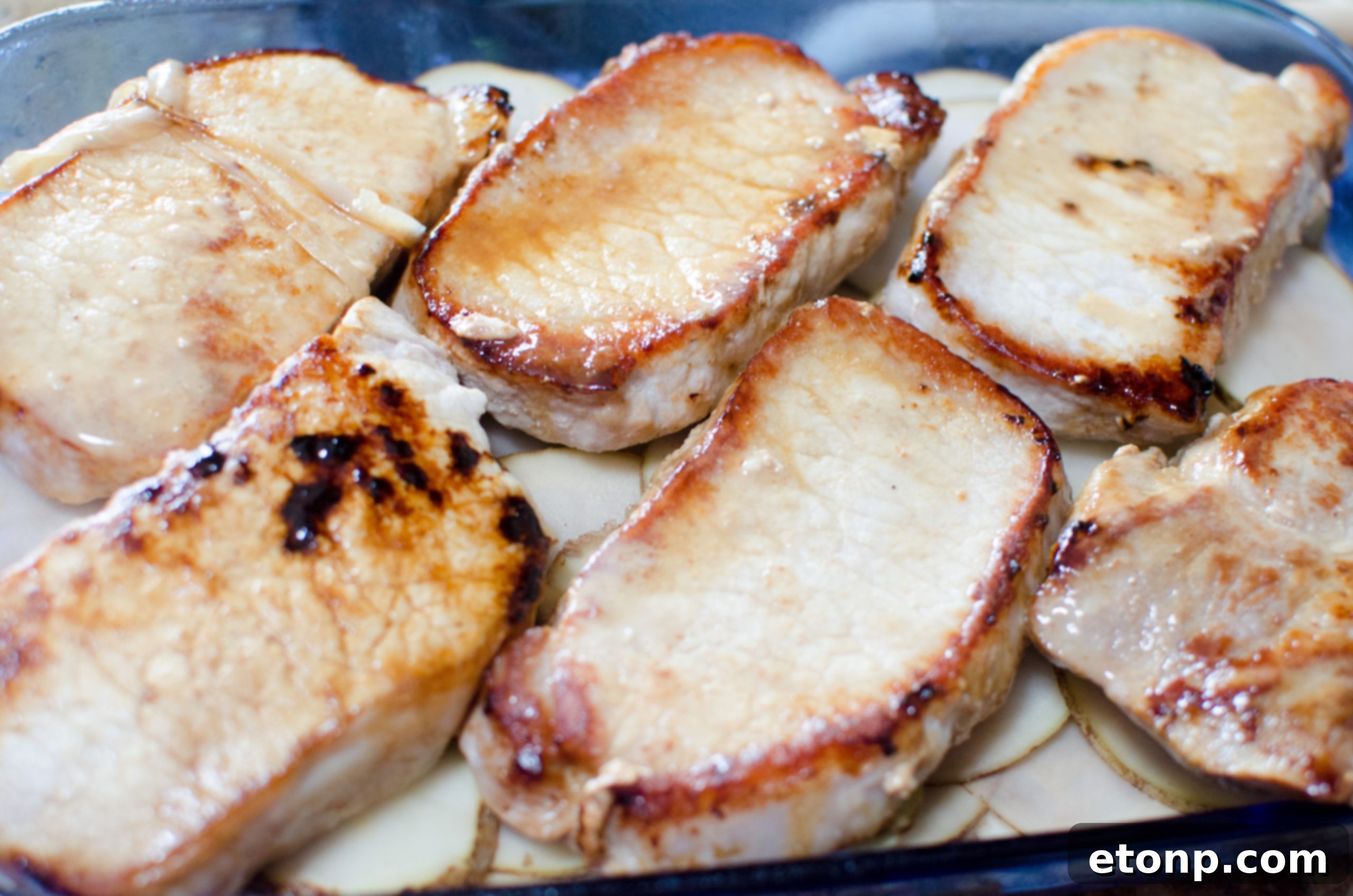 Smothered Pork Chops and Scalloped Potatoes Casserole 5 Sautéed sliced onions softening in butter in a large skillet, adding depth to the casserole sauce.