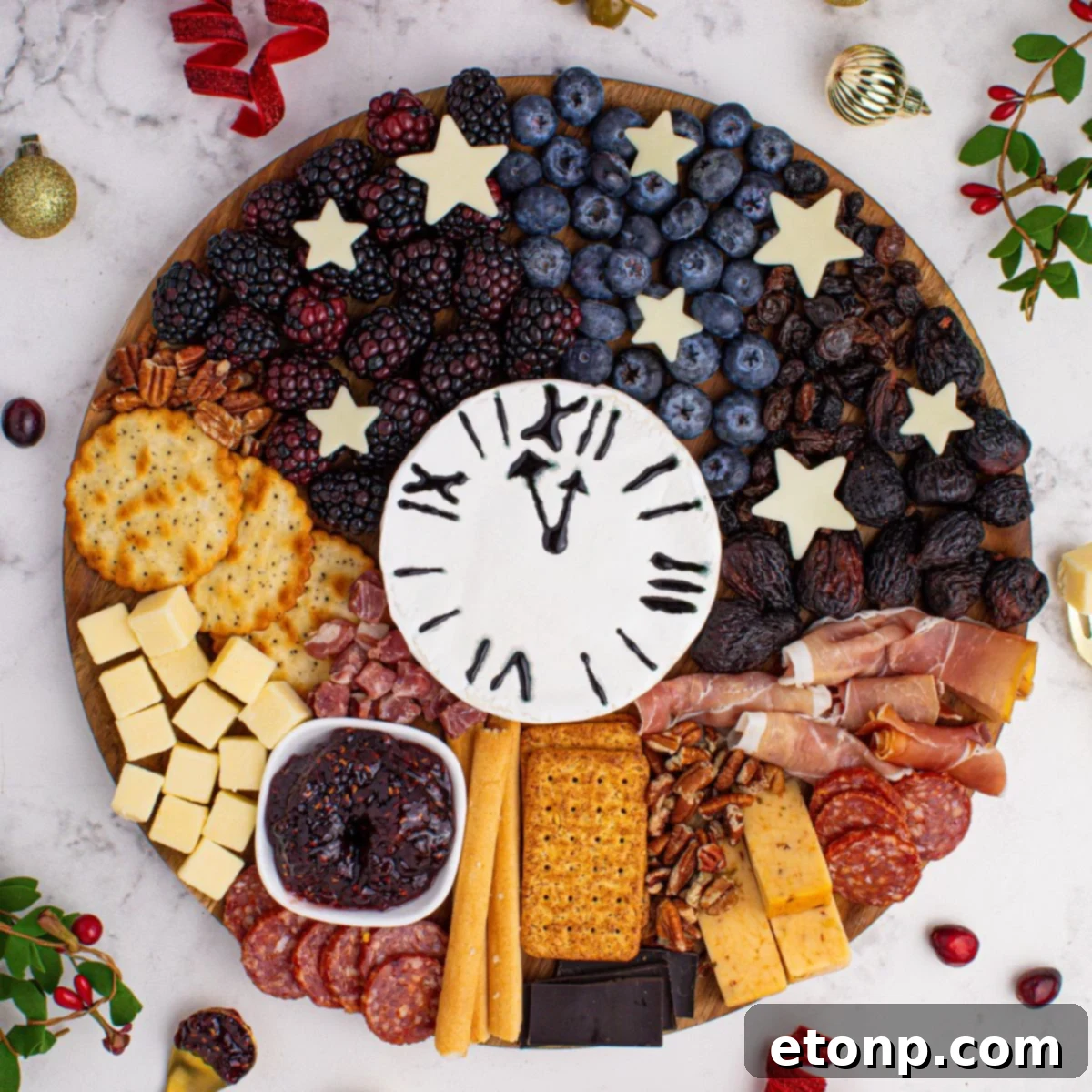 New Year's Eve Charcuterie Board on table with some garnishments around the charcuterie board 