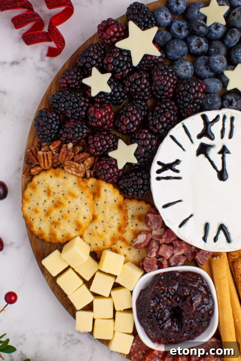side view of the New Year's Eve Charcuterie Board on a table with some food sprinkled around it on table 