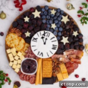 New Year's Eve Charcuterie Board on table with some garnishments around the charcuterie board