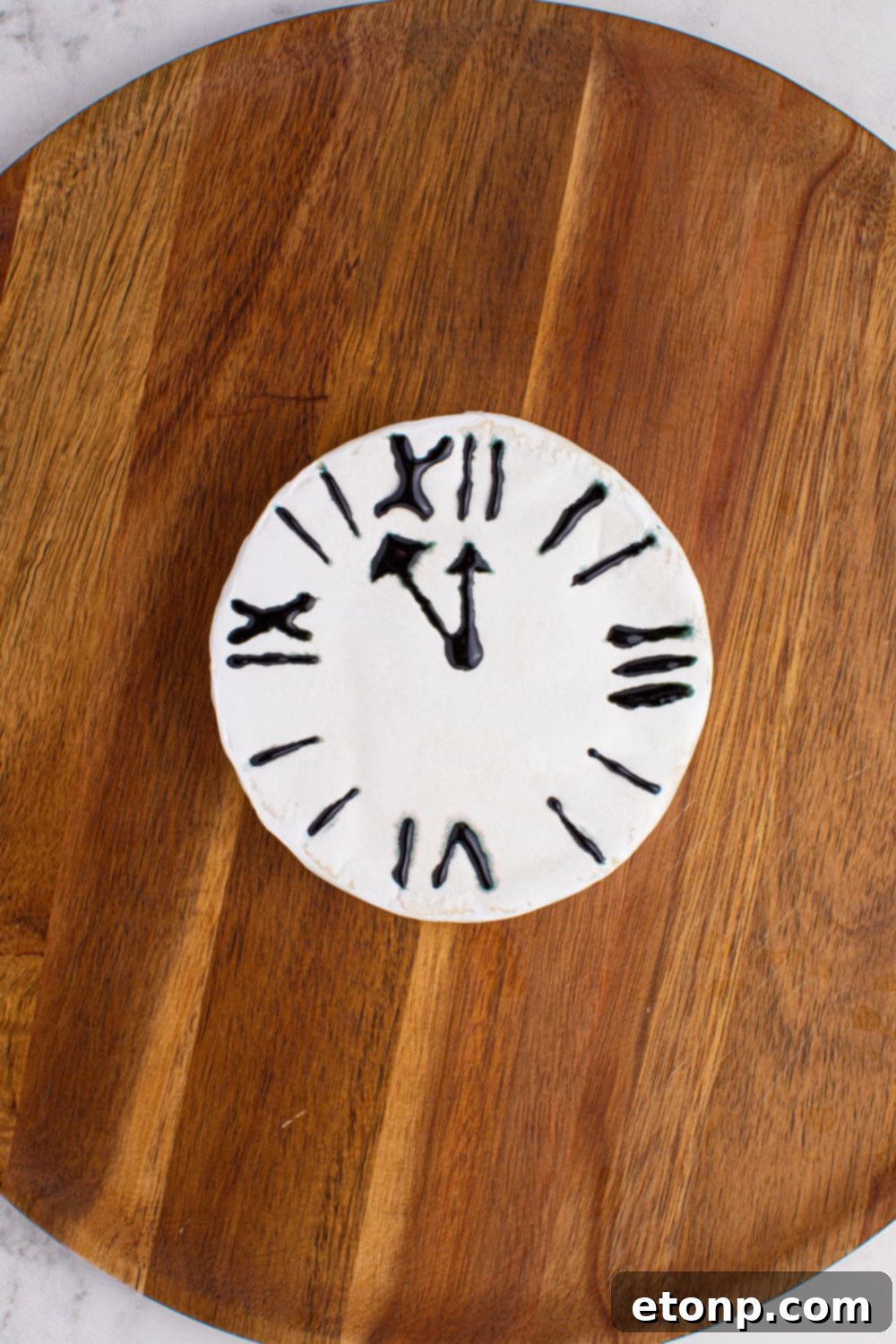 New Year's Eve Charcuterie Board being started to assemble. The brie cheese with clock drawn on 