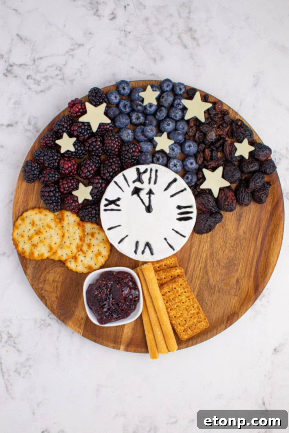 New Year's Eve Charcuterie Board with fruit and crackers  spread on a serving tray 