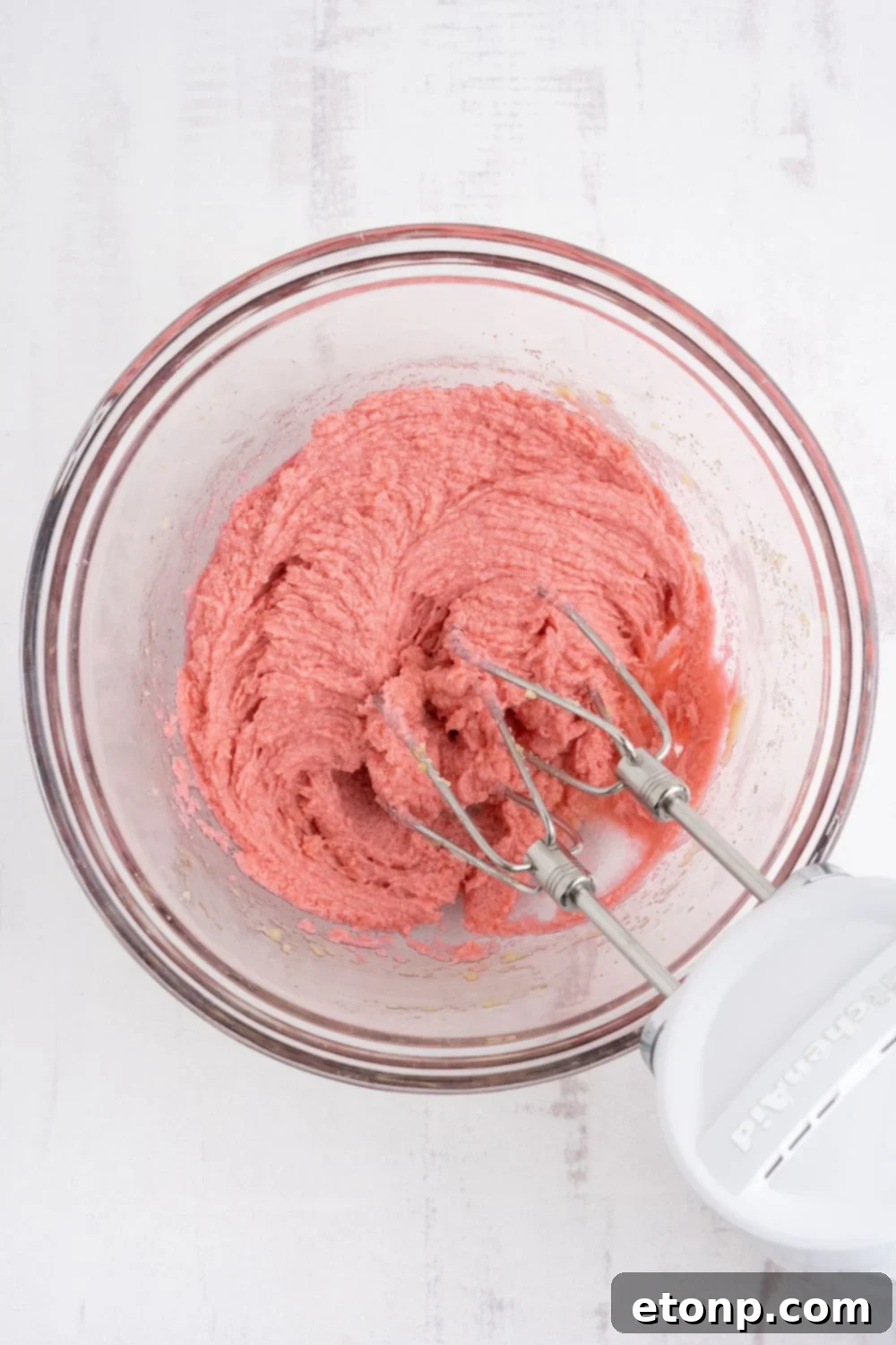 The prochess of mixing up the Cherry Chocolate Chip Cookie dough in a glass bowl 
