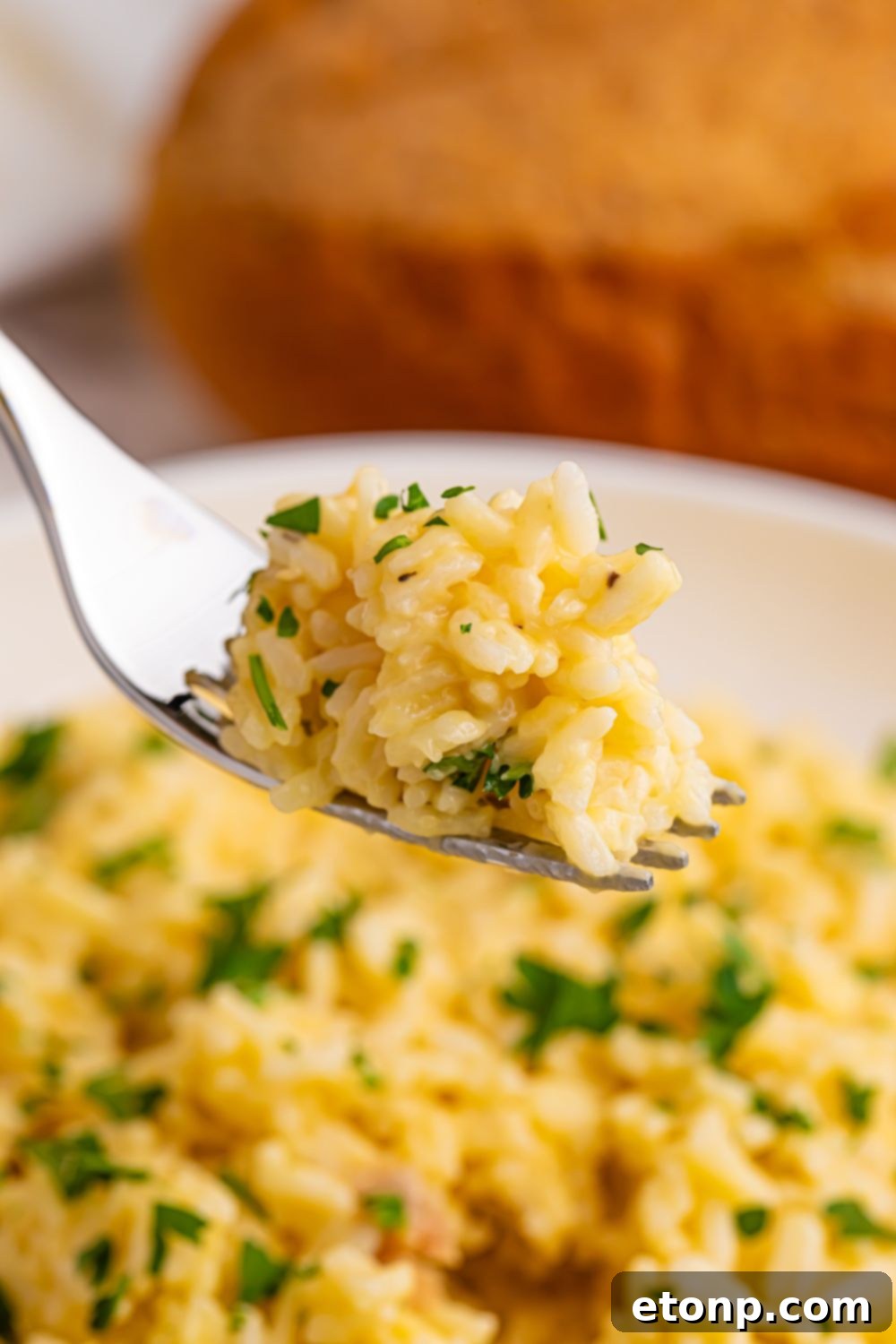 Souper Rice on a fork with some chopped parsley on top 