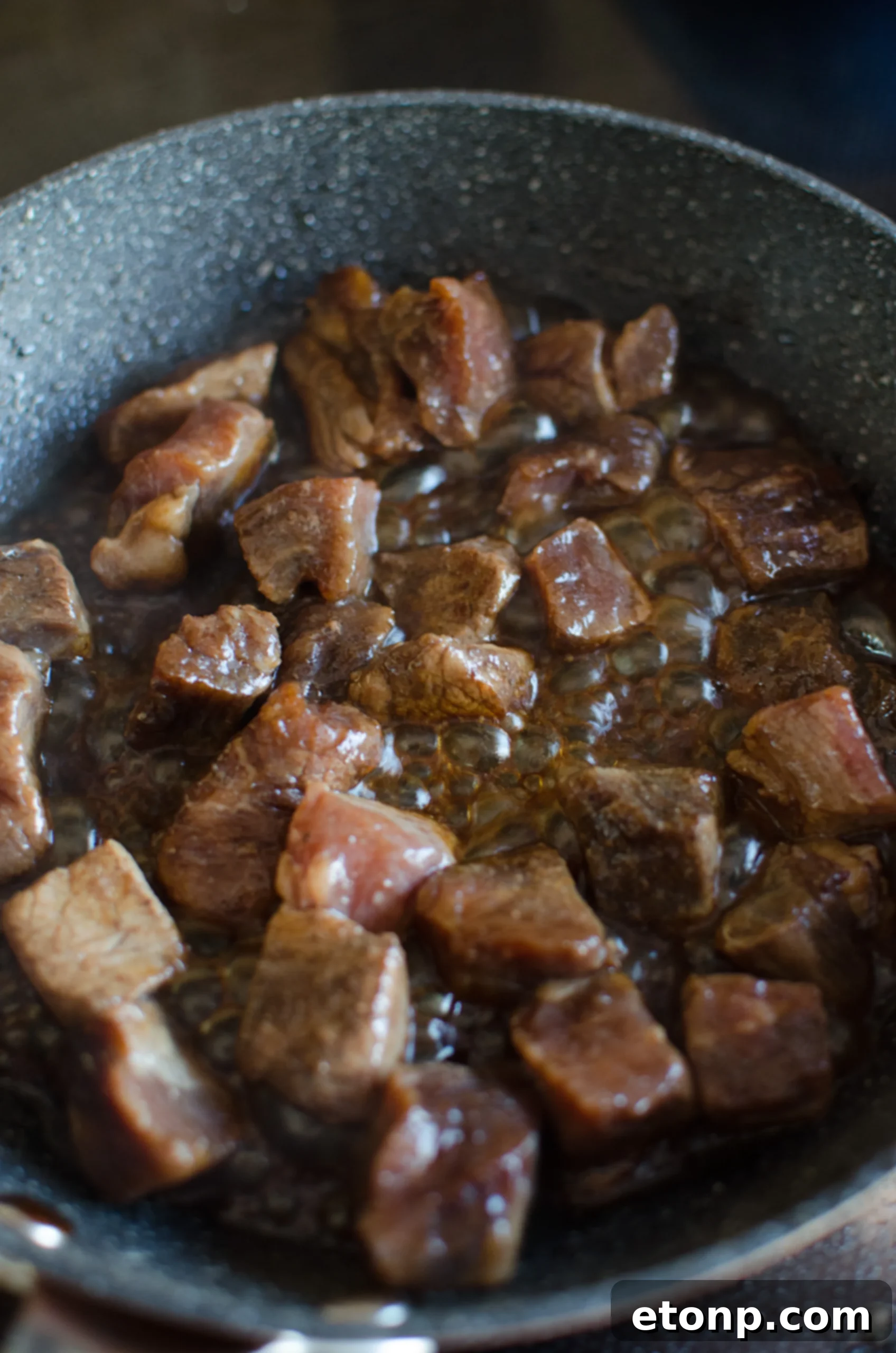 A bowl of Asian marinade ingredients: soy sauce, honey, chili paste, garlic, and sesame oil.