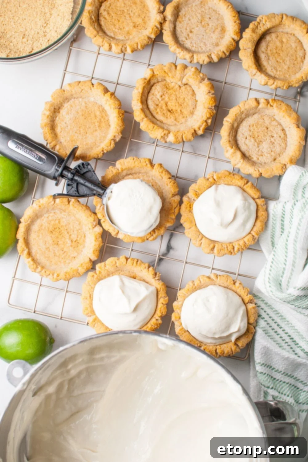 Crumbl Key Lime Pie Cookie filling being placed in the center of each cookie with the filling