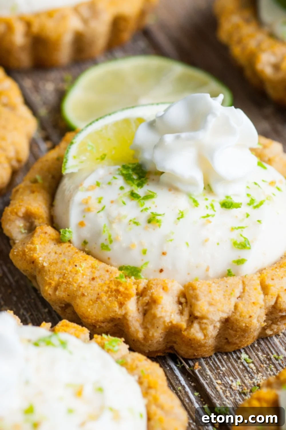 close up of Crumbl Key Lime Pie Cookies on table lined out in rows