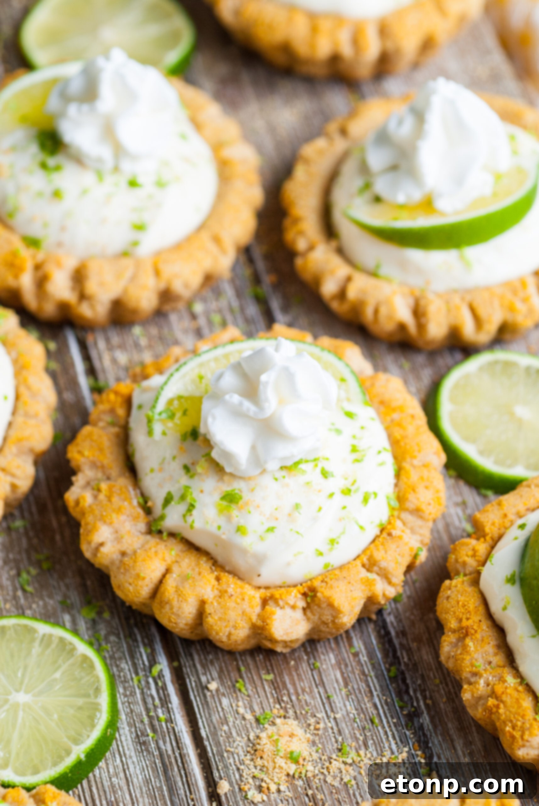 Crumbl Key Lime Pie Cookies on table with lime wedges