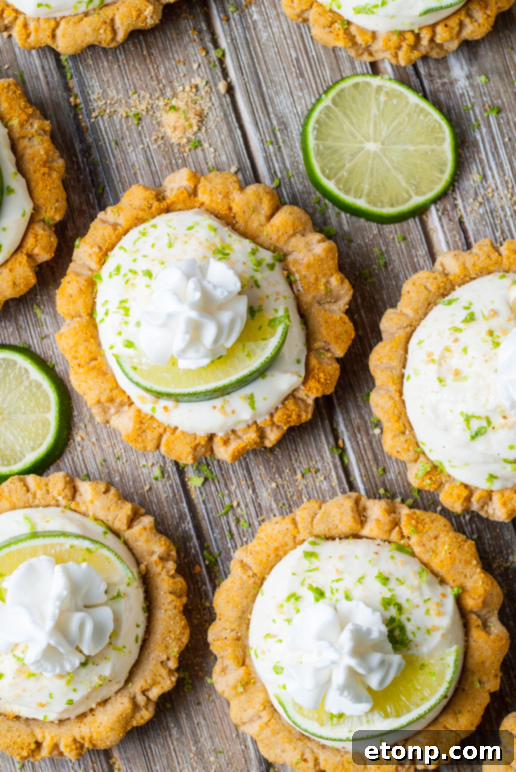 overhead shot of the Crumbl Key Lime Pie Cookies on table with lime wedges