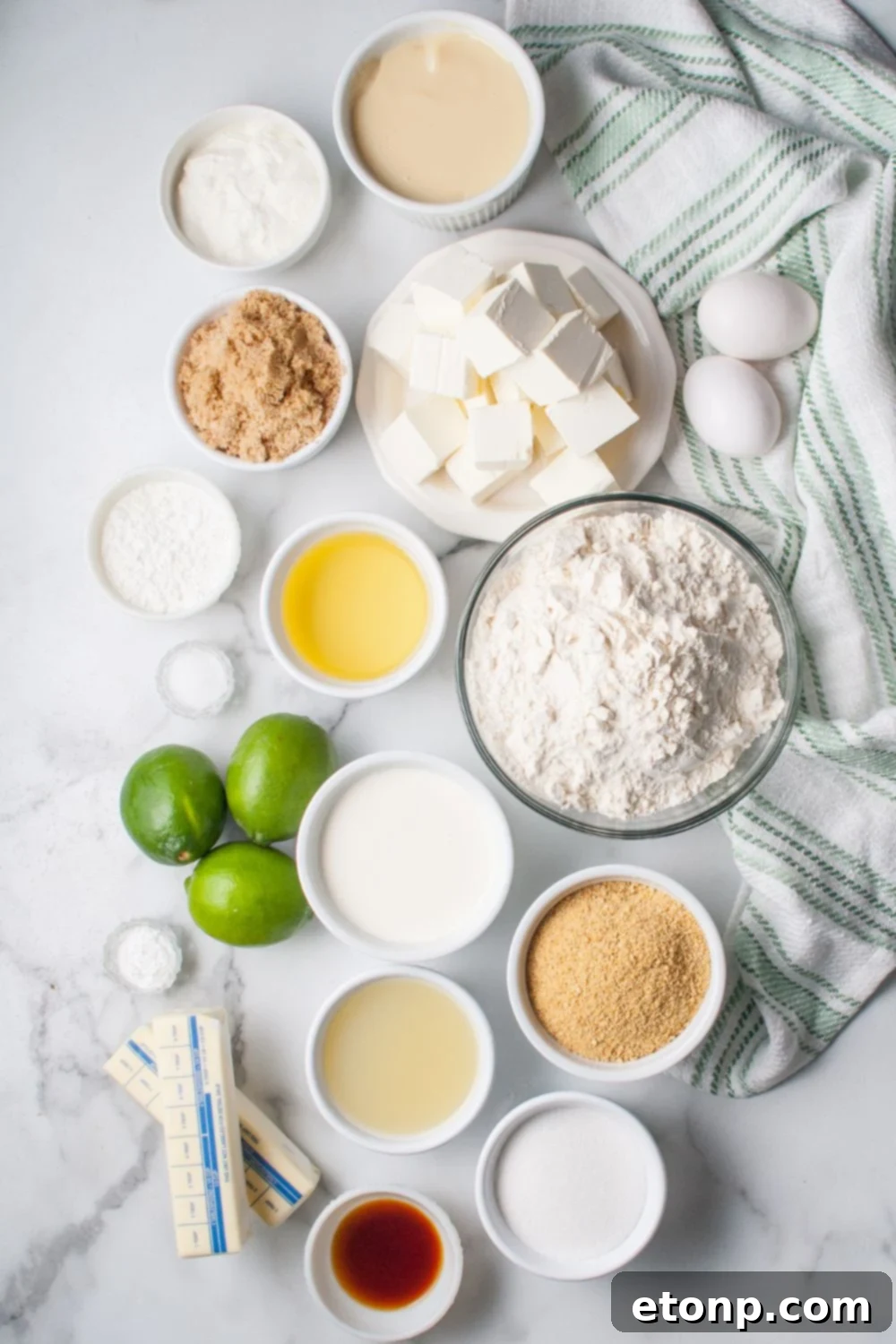 Crumbl Key Lime Pie Cookies- all the ingredients for the key lime pie cookies in single serve bowls on the table with a towel under it