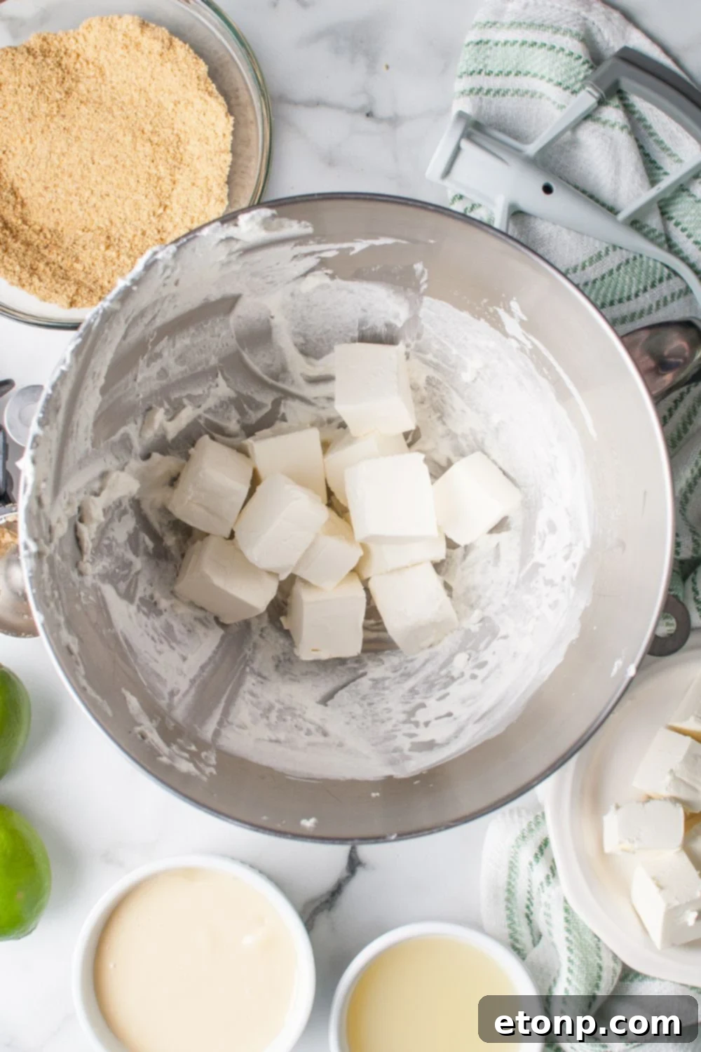 diced pieces of cream cheese in the bowl for making Crumbl Key Lime Pie Cookies