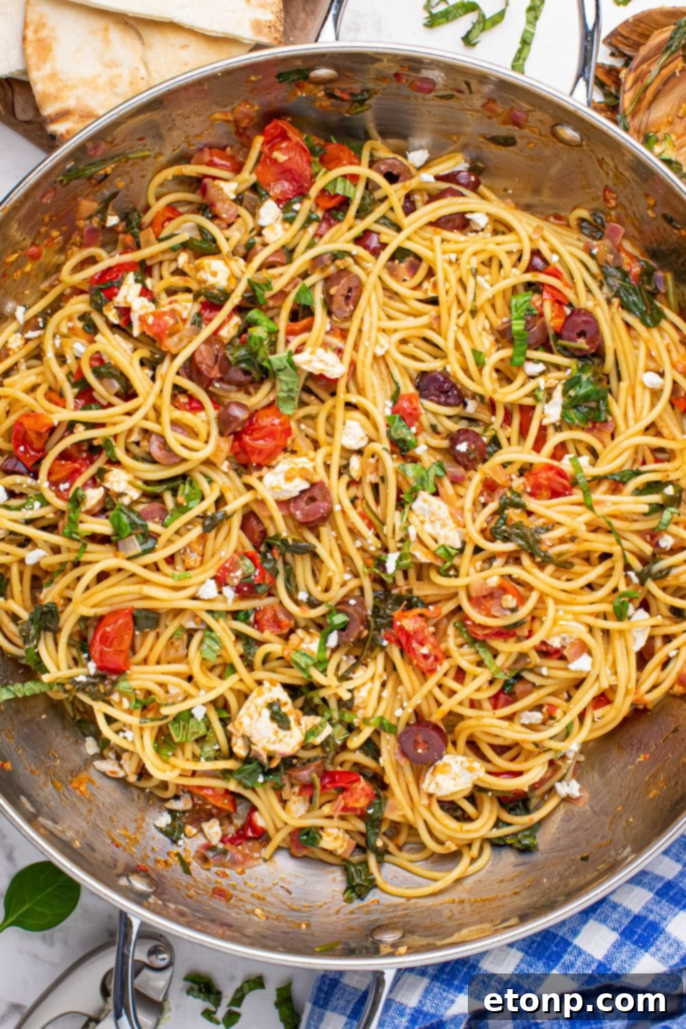 Greek Spaghetti fully tossed and ready to serve in a large pan, showing a harmonious blend of pasta and vegetables
