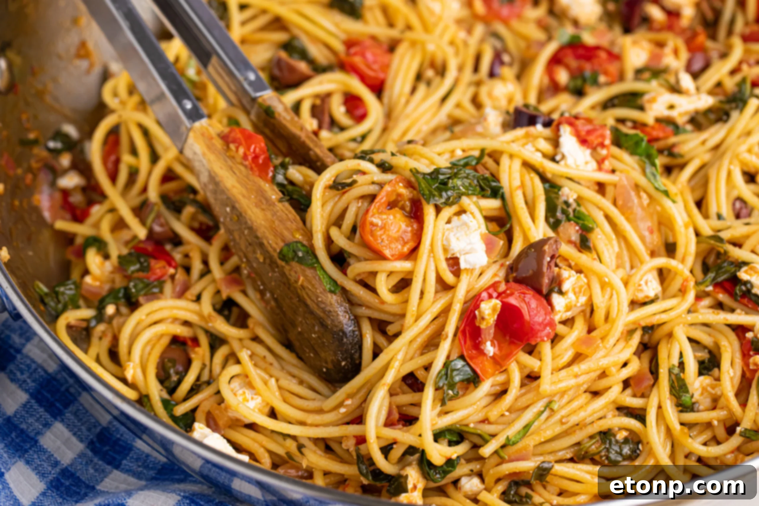 Greek Spaghetti resting in a gleaming stainless steel skillet, ready to be served
