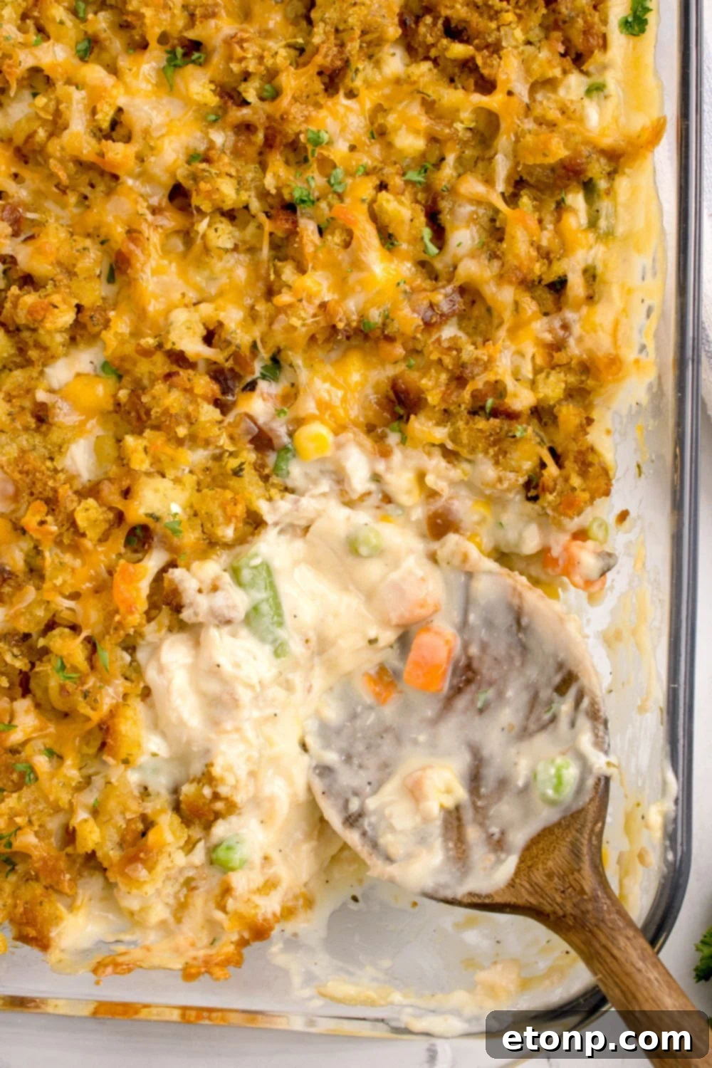 Chicken Stuffing Casserole in pan with a few scoops missing from pan showing the center of the casserole 