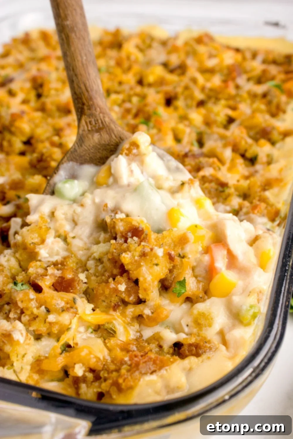 Chicken Stuffing Casserole with a scoop being lifted out of the casserole dish 