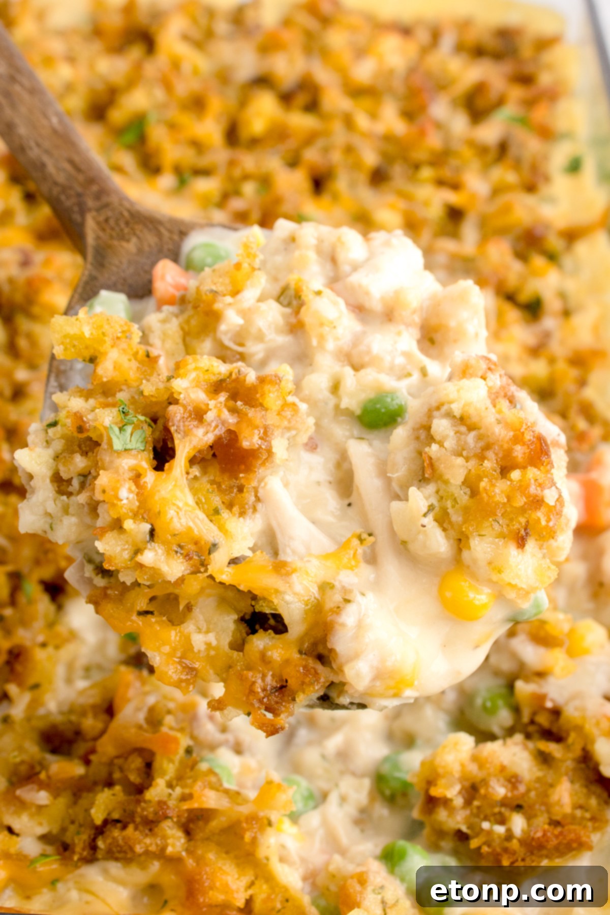 Chicken Stuffing Casserole with a scoop being lifted out of the casserole dish 