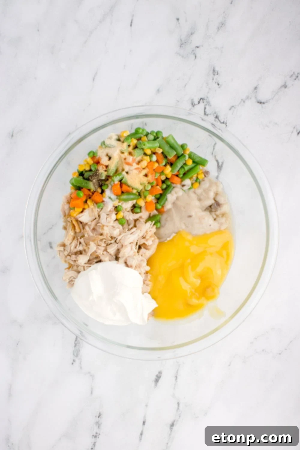 Chicken Stuffing Casserole ingredients in a glass bowl on table 