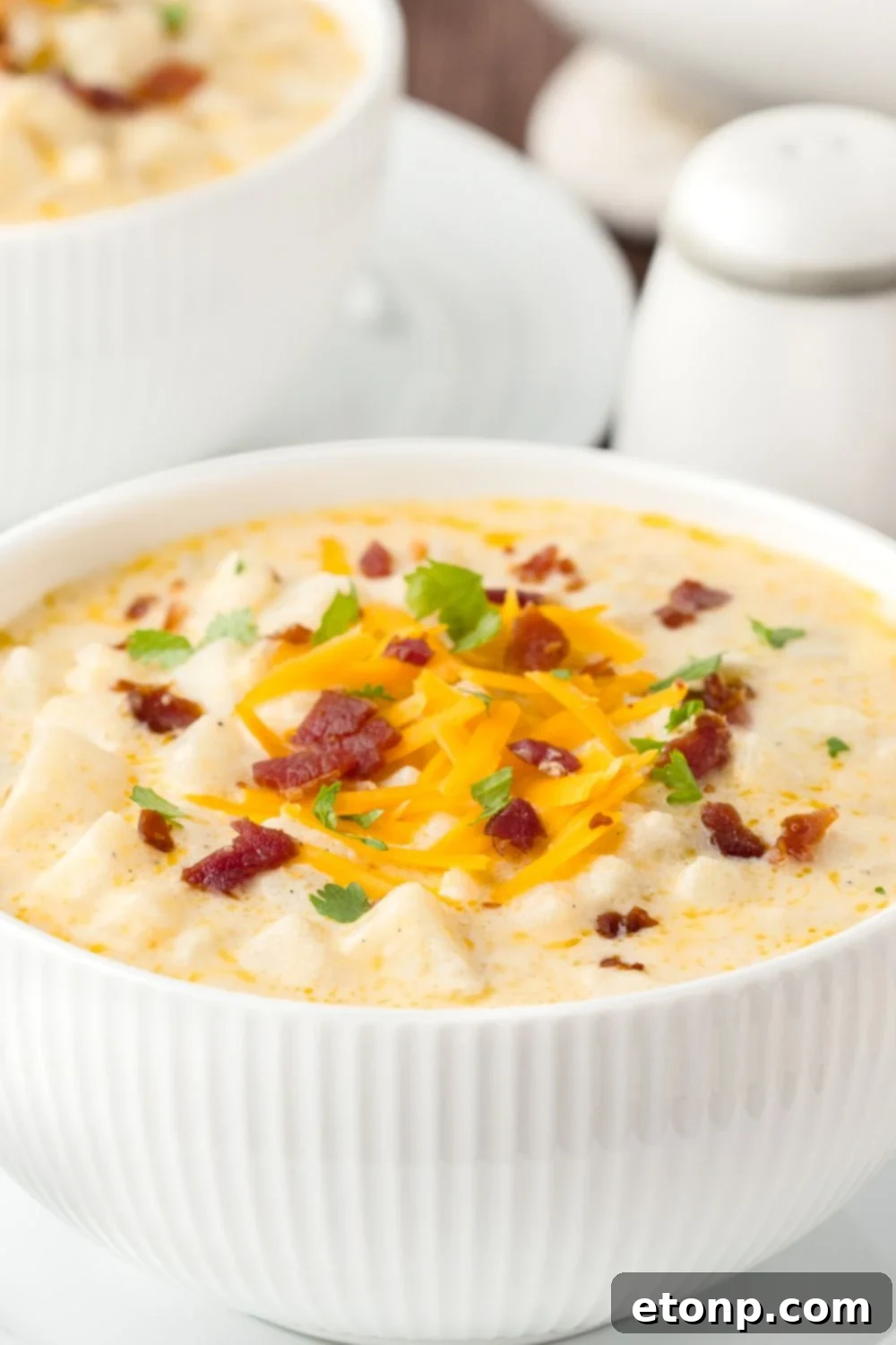 close up look of Hash Brown Potato Soup in a bowl on table 