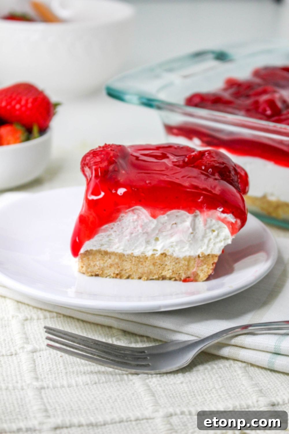 No Bake Strawberry Delight on plate with a fork on table 