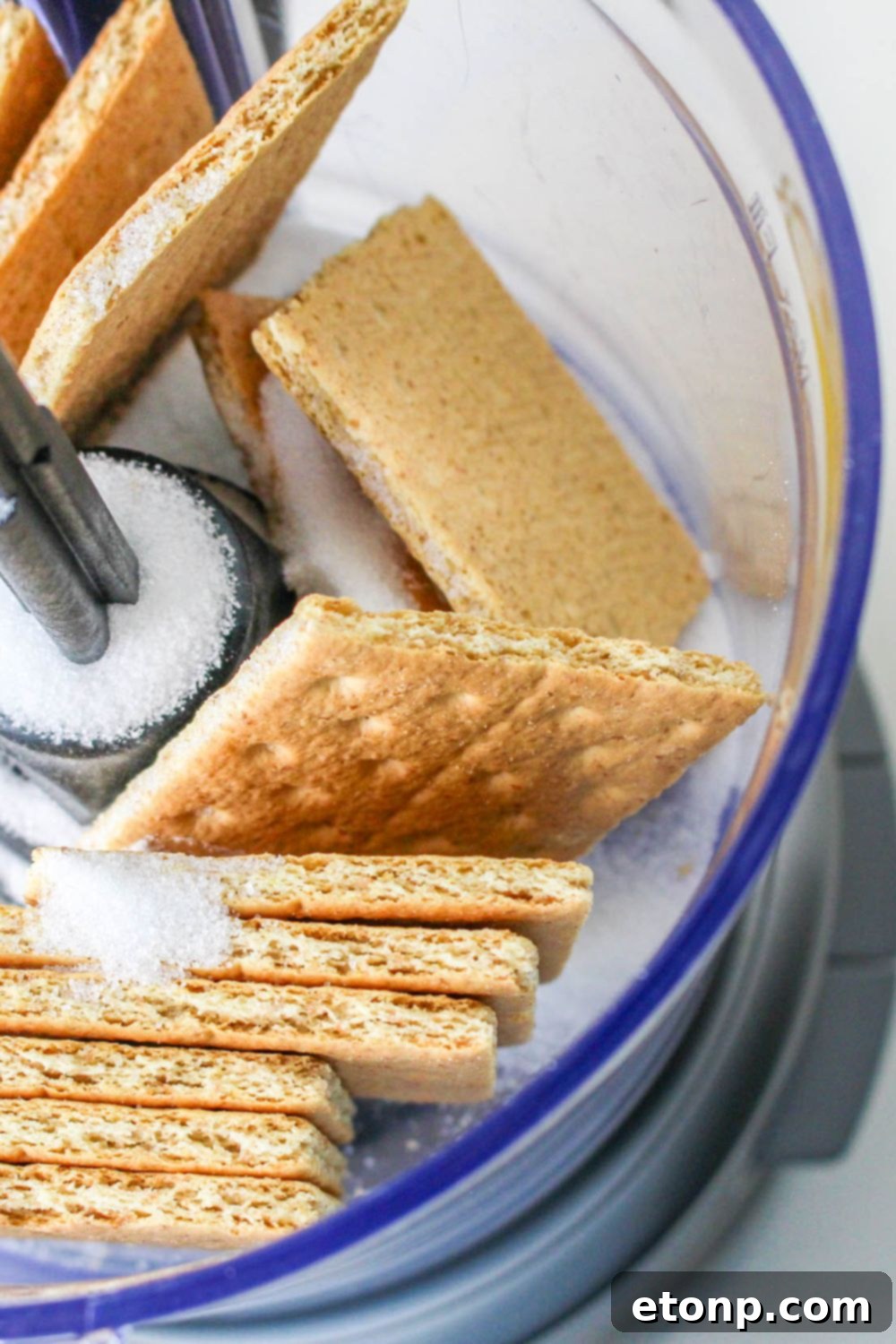 food processor with crackers and sugar in it for making the No Bake Strawberry Delight