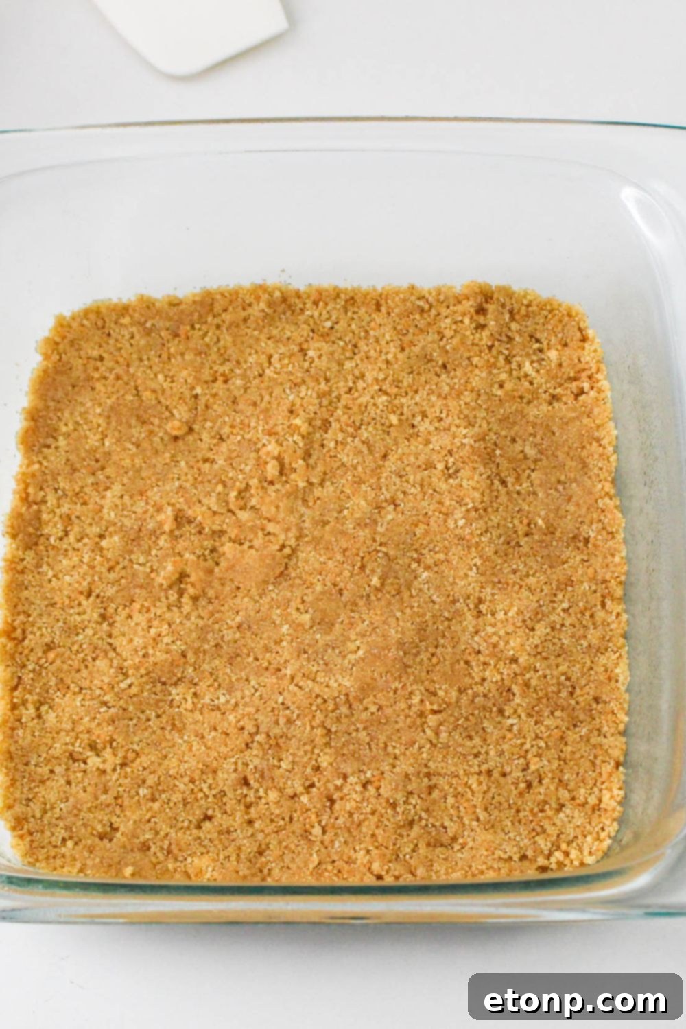graham cracker crust pressed into pan for the No Bake Strawberry Delight