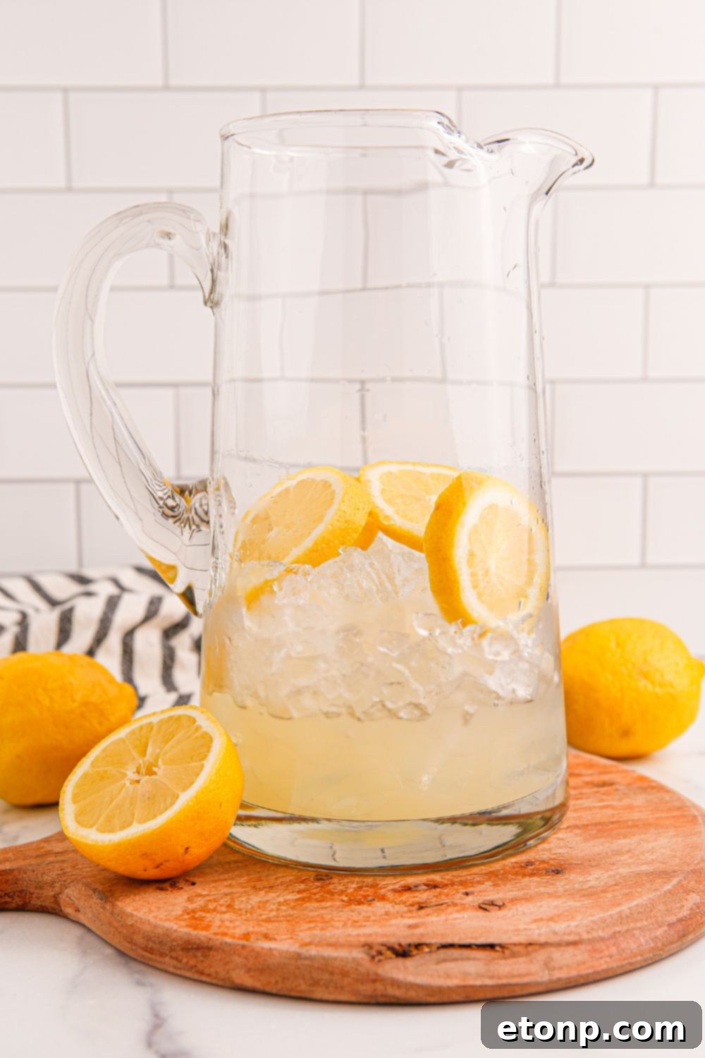 Freshly squeezed lemonade concentrate being poured into a pitcher, forming the base for Blue Raspberry Lemonade.