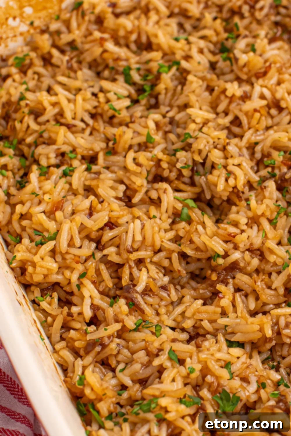 Fluffy Stick of Butter Rice in a pan, lightly fluffed with a fork, ready to be served.