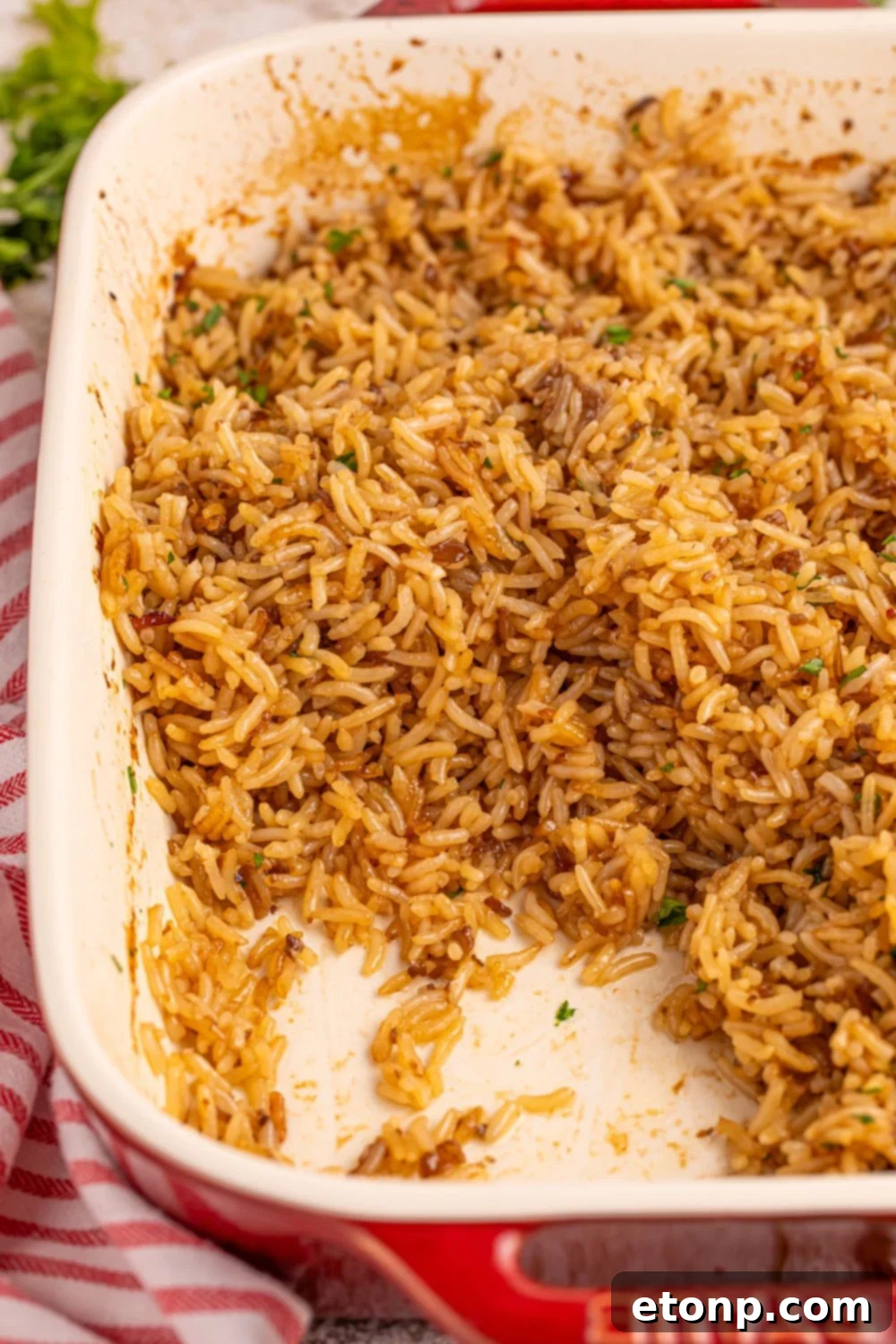 A pan of Stick of Butter Rice with a portion scooped out, showing its tender texture.