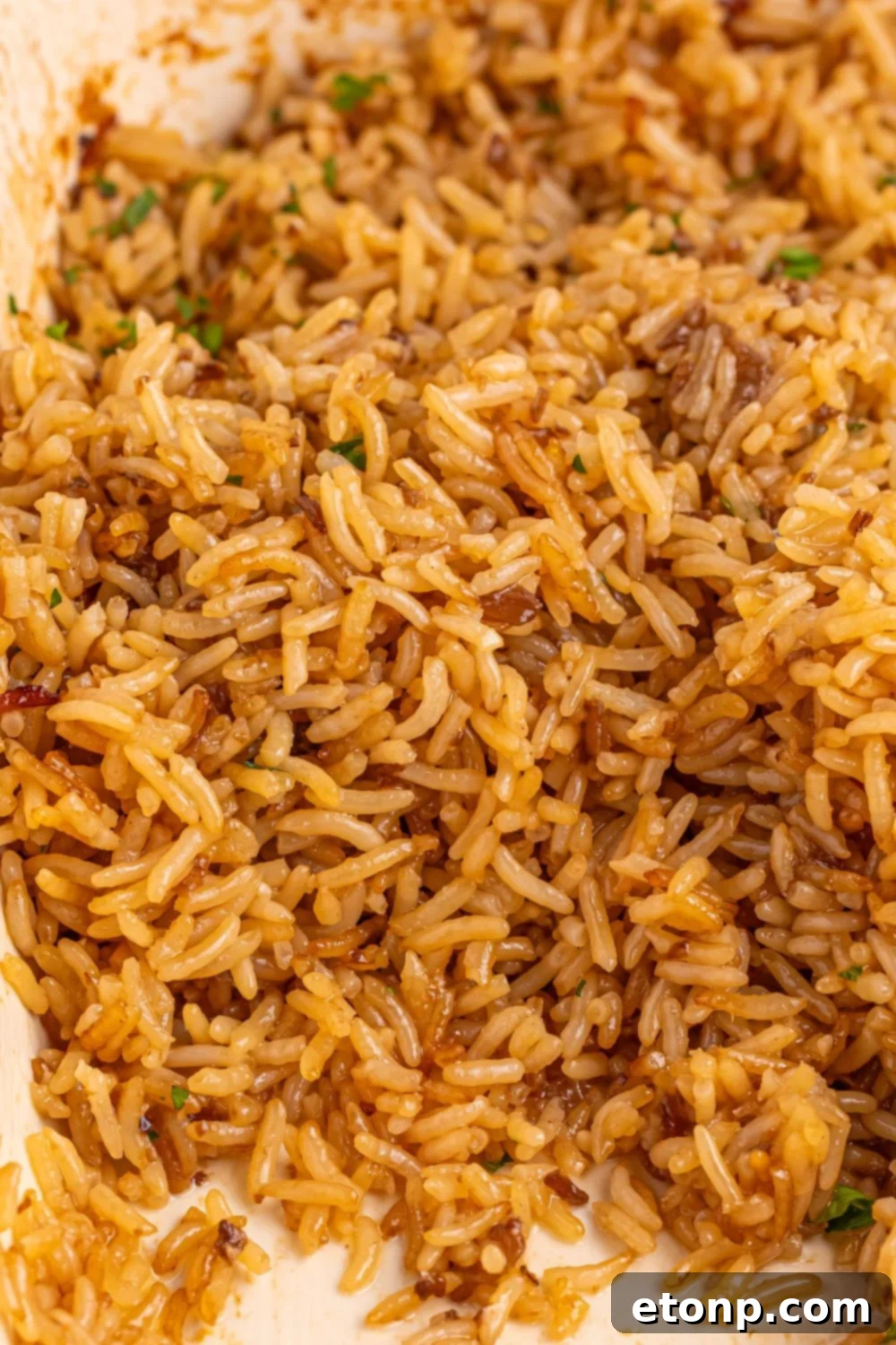 Stick of Butter Rice served on a white plate, with a portion already enjoyed.
