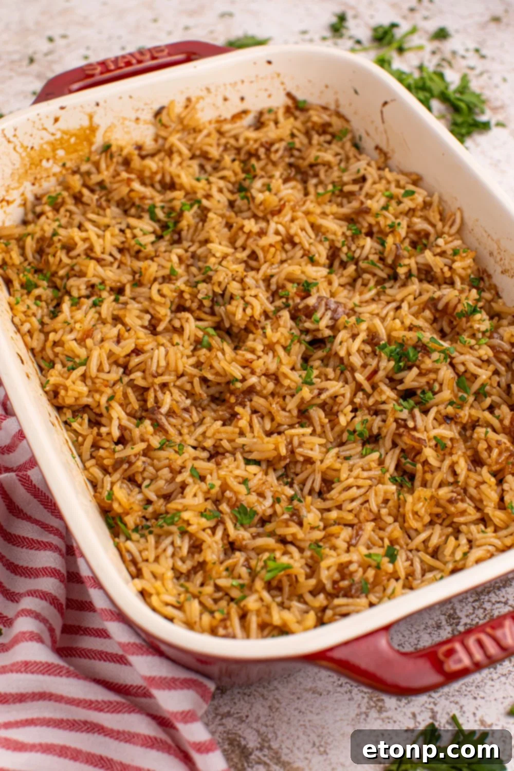 Fully cooked Stick of Butter Rice, fluffy and golden, presented in the baking pan on a wooden table.