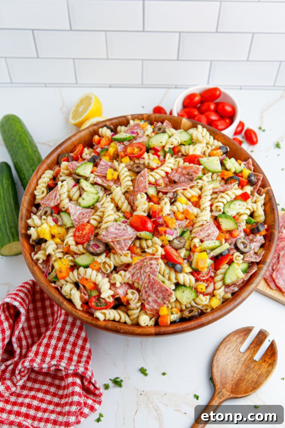 Vibrant Summer Pasta Salad 11 Summer Pasta Salad in a wooden bowl on table with vegetables around it
