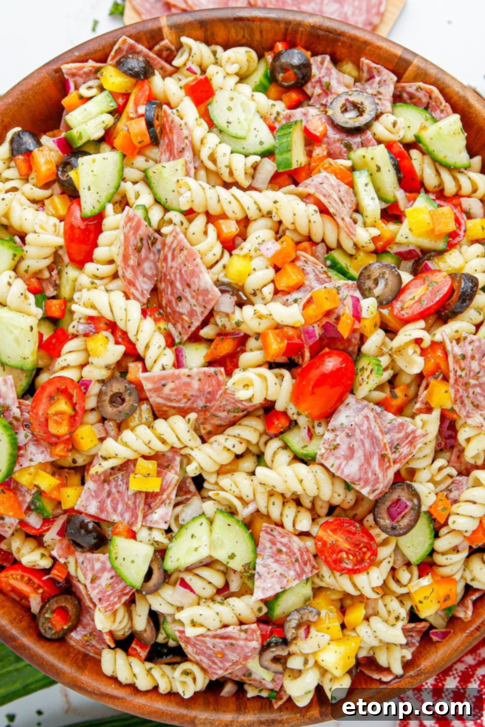 Vibrant Summer Pasta Salad 15 Summer Pasta Salad in a wooden bowl with overhead shot of it on table