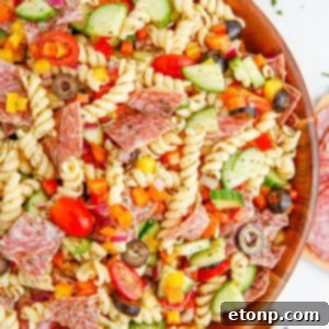 Vibrant Summer Pasta Salad 19 Summer Pasta Salad in a wooden bowl on table