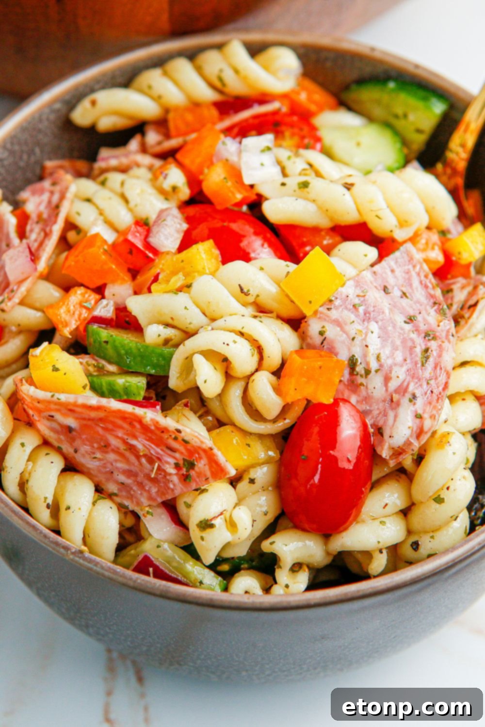 Vibrant Summer Pasta Salad 9 Summer Pasta Salad in a bowl on table with close up of vegetables