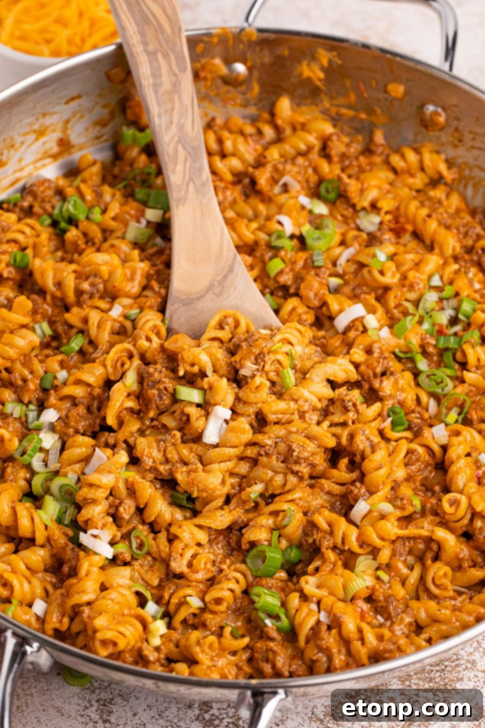 Taco Macaroni and Cheese in a pan with a spoon in the pan 