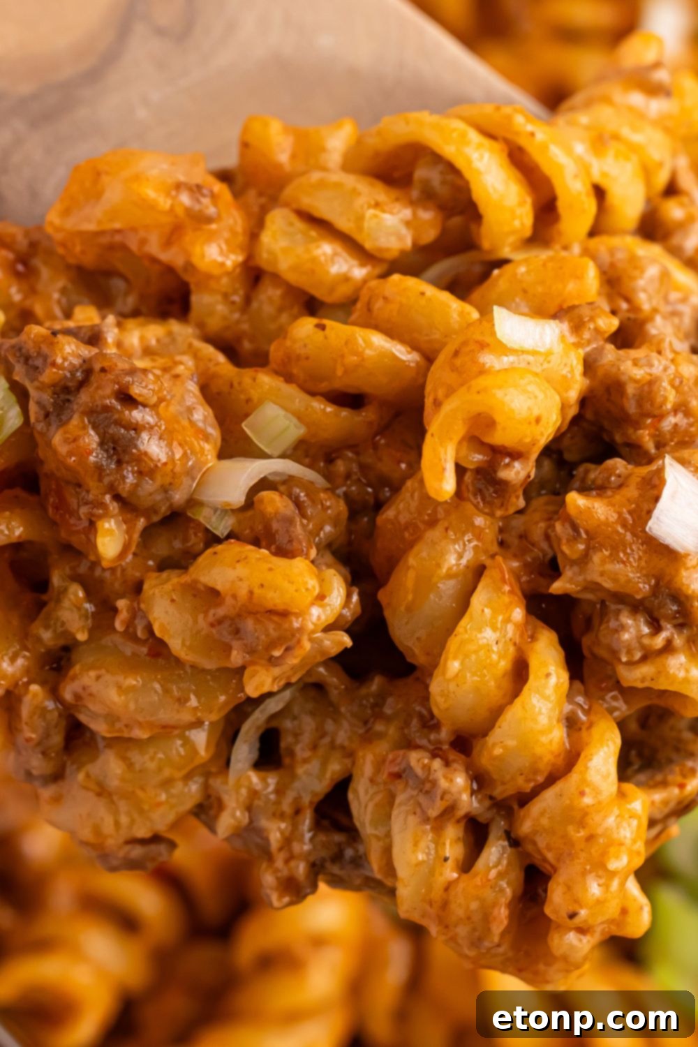 Taco Macaroni and Cheese in a pan with a close up of pasta in a pan 