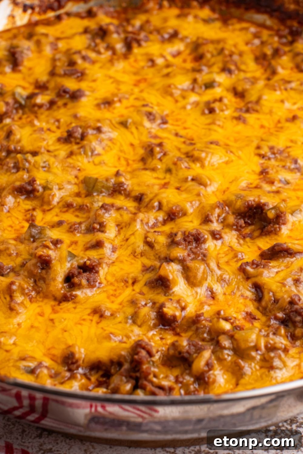 Ultimate Sloppy Joe Dip 15 A pan of Sloppy Joe Dip, generously topped with perfectly melted and bubbly cheddar cheese, ready to be served.