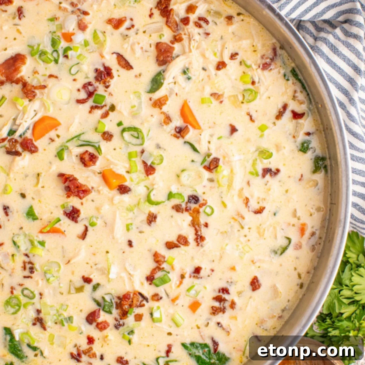 Creamy Ranch Chicken Soup 3 Crack Chicken Soup in a pan with a towel under it