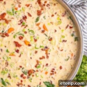 Creamy Ranch Chicken Soup 21 Crack Chicken Soup in a pan with a towel under it