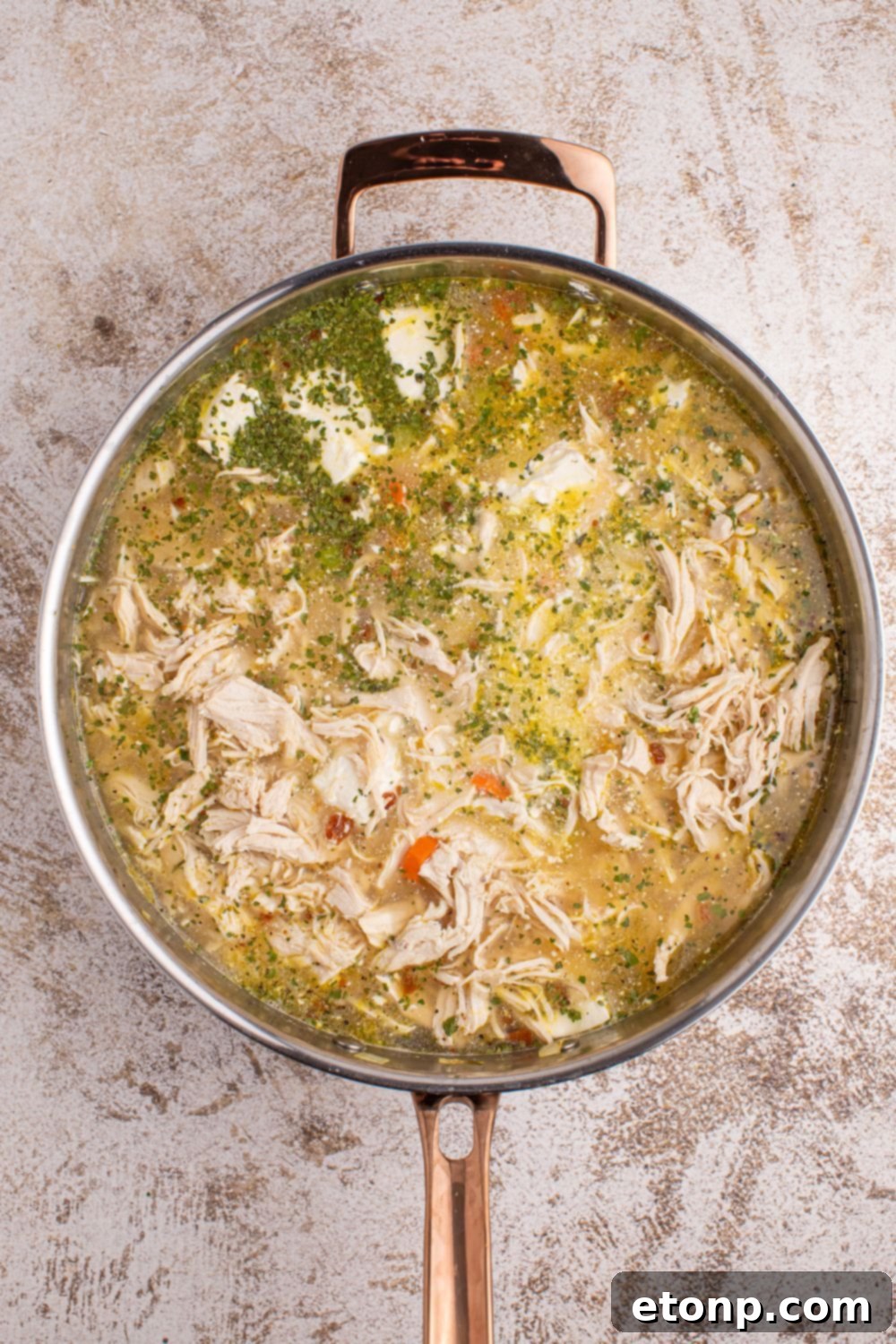 Creamy Ranch Chicken Soup 8 mixing up Crack Chicken Soup ingredients in a metal pan on table