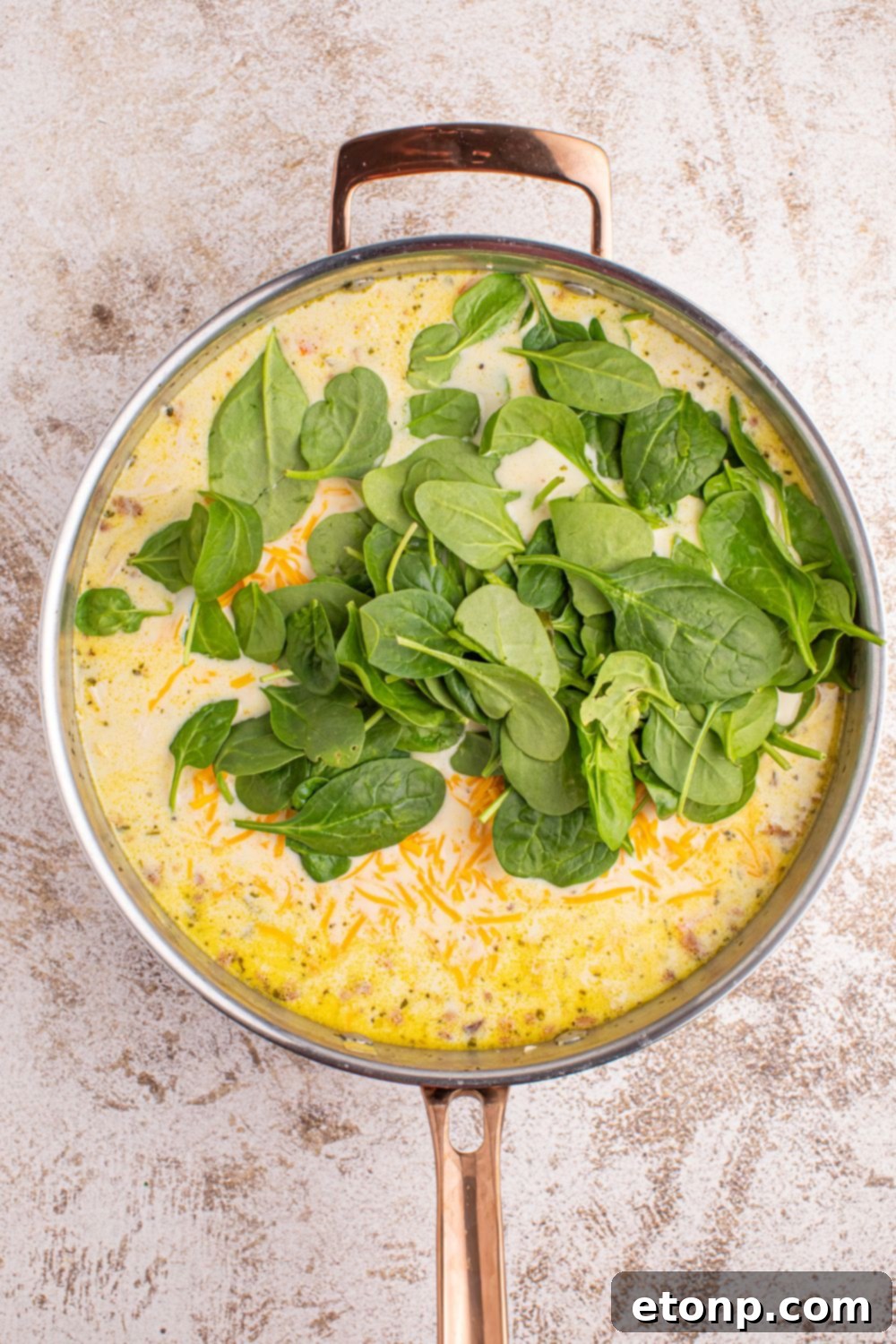 Creamy Ranch Chicken Soup 9 spinach poured into pan of Crack Chicken Soup in it